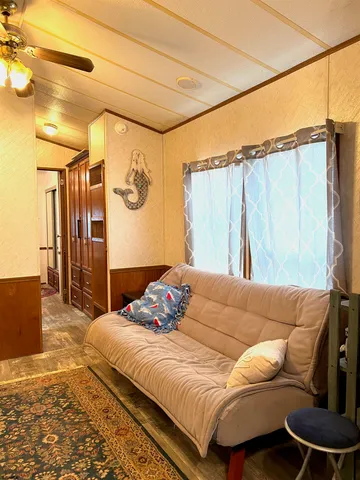 a view of empty room with wooden floor and windows