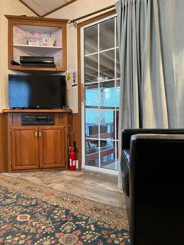 a view of room with window and a flat screen tv