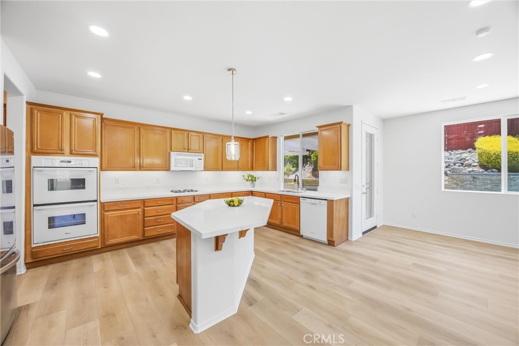 8710 Windmill Place Riverside, CA 92508 - Photo 19 of 66 a kitchen with a stove a sink and a refrigerator