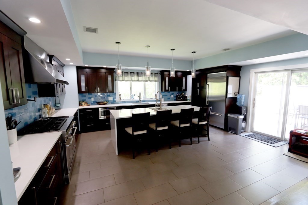 26 Chamberlain Road Chelmsford, MA 01824 - Photo 1 of 35 a living room with furniture and a flat screen tv
