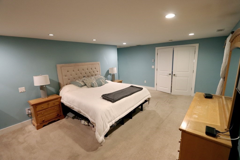 26 Chamberlain Road Chelmsford, MA 01824 - Photo 11 of 35 a spacious bedroom with a bed and a couch