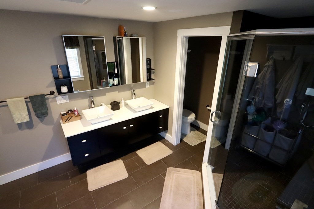 26 Chamberlain Road Chelmsford, MA 01824 - Photo 12 of 35 a bathroom with a double vanity sink and mirror