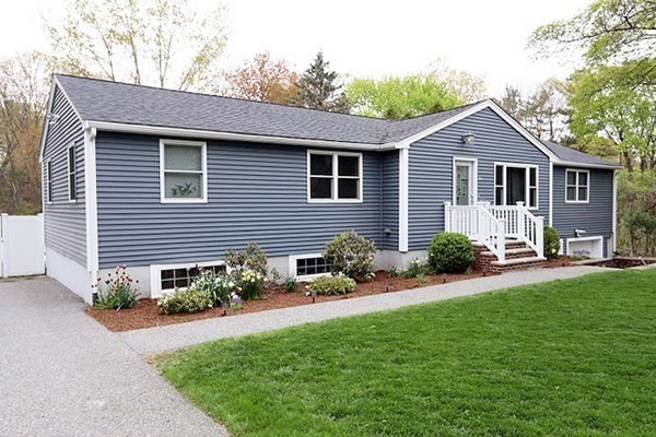 26 Chamberlain Road Chelmsford, MA 01824 - Photo 2 of 35 a front view of a house with a yard and potted plants