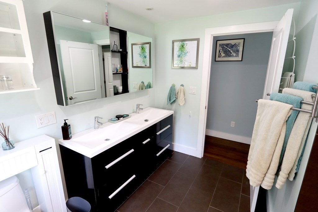 26 Chamberlain Road Chelmsford, MA 01824 - Photo 21 of 35 a bathroom with a sink mirror and vanity