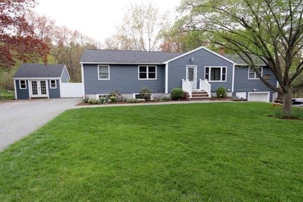 26 Chamberlain Road Chelmsford, MA 01824 - Photo 3 of 35 a front view of a house with a garden and trees