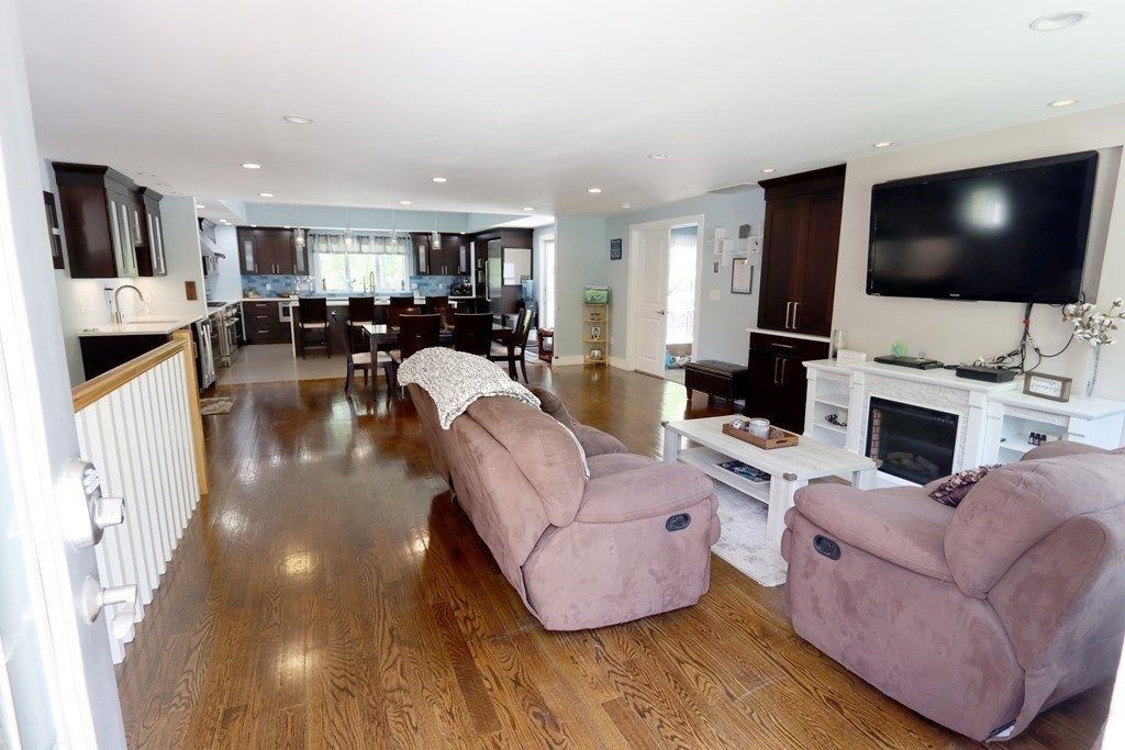 26 Chamberlain Road Chelmsford, MA 01824 - Photo 8 of 35 a living room with fireplace furniture and a flat screen tv