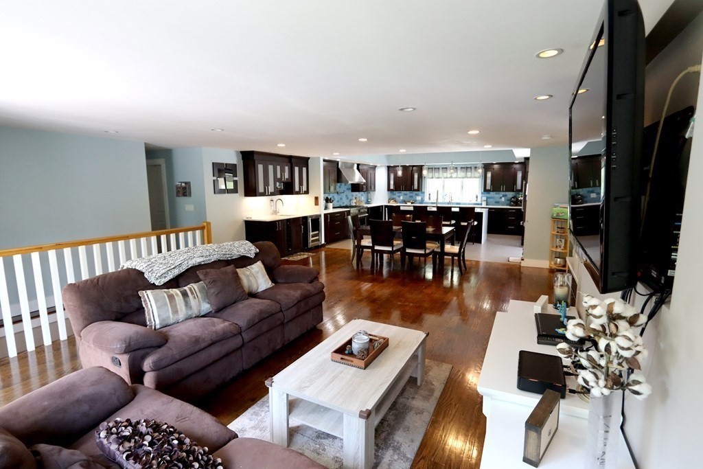 26 Chamberlain Road Chelmsford, MA 01824 - Photo 9 of 35 a living room with furniture a dining table and a flat screen tv