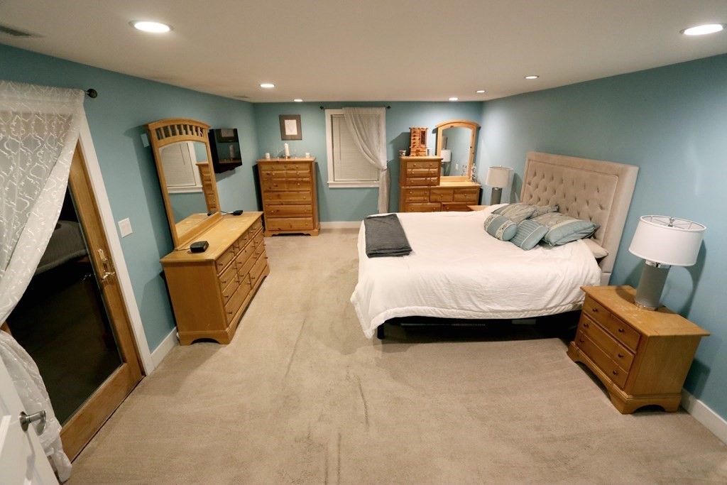 26 Chamberlain Road Chelmsford, MA 01824 - Photo 10 of 35 a bedroom with furniture and a flat screen tv