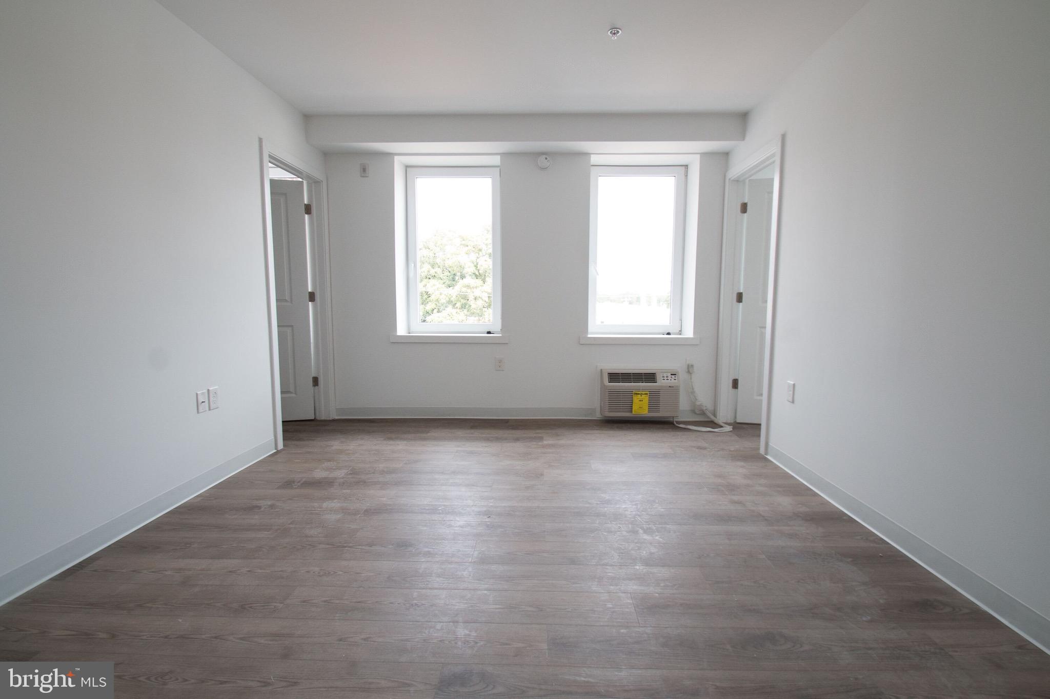 5850 North 13th Street, Unit 306 Philadelphia, PA 19141 - Photo 2 of 4 an empty room with windows