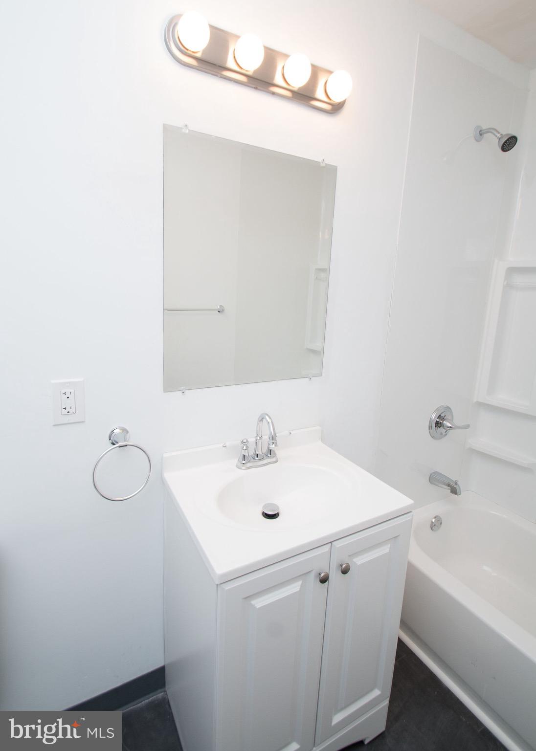 5850 North 13th Street, Unit 306 Philadelphia, PA 19141 - Photo 4 of 4 a bathroom with a sink a toilet and bathtub