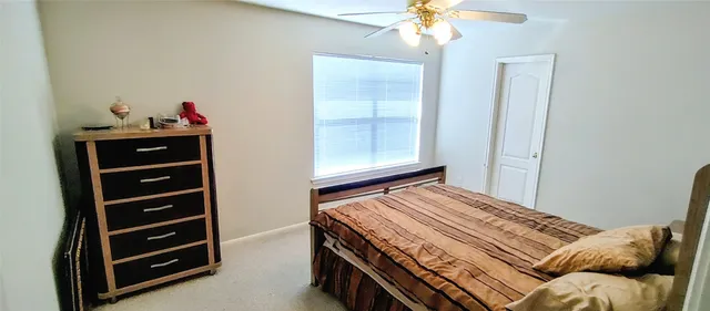 a bedroom with a bed and a window