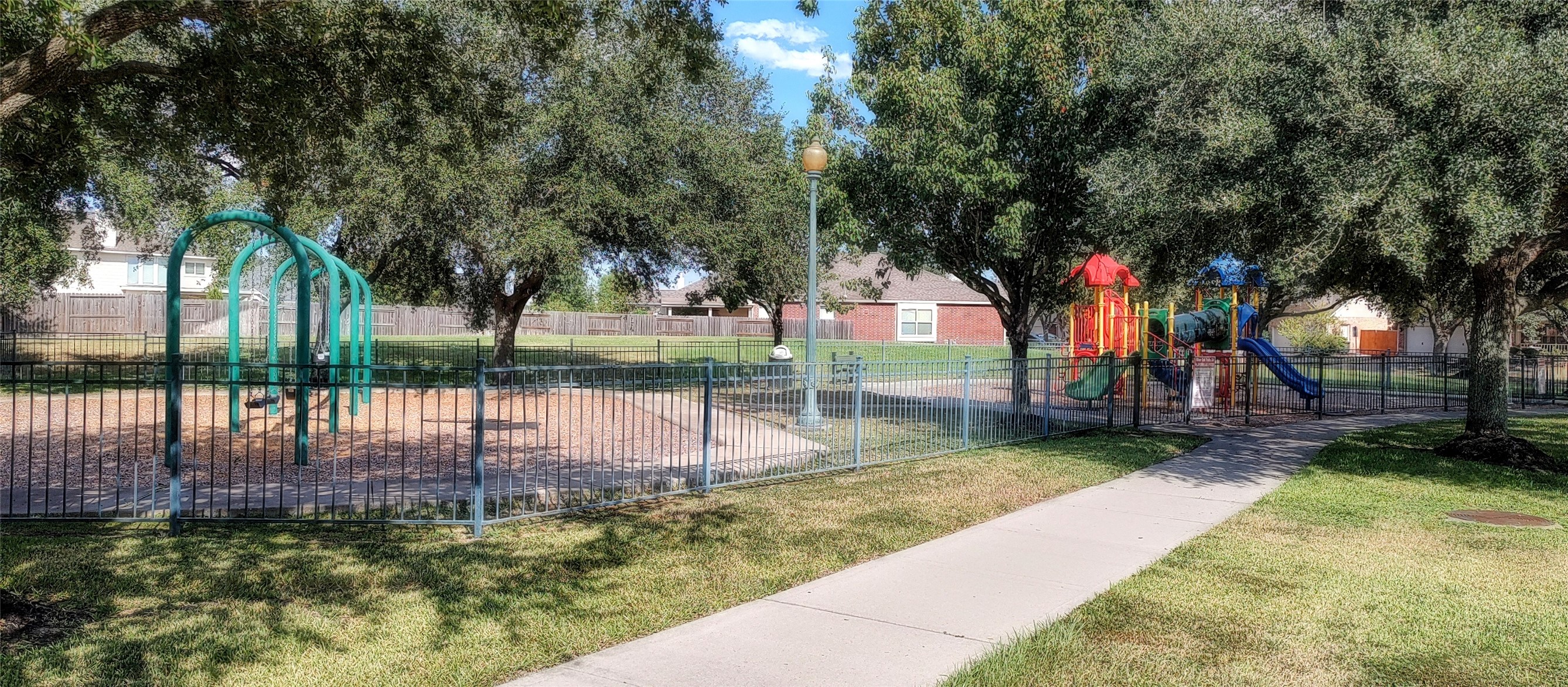 10234 Turrett Point Lane Houston, TX 77064 - Photo 13 of 17 a view of a park with swings and a table and chairs