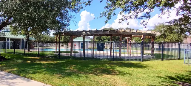 a view of a backyard with a garden and entertaining space