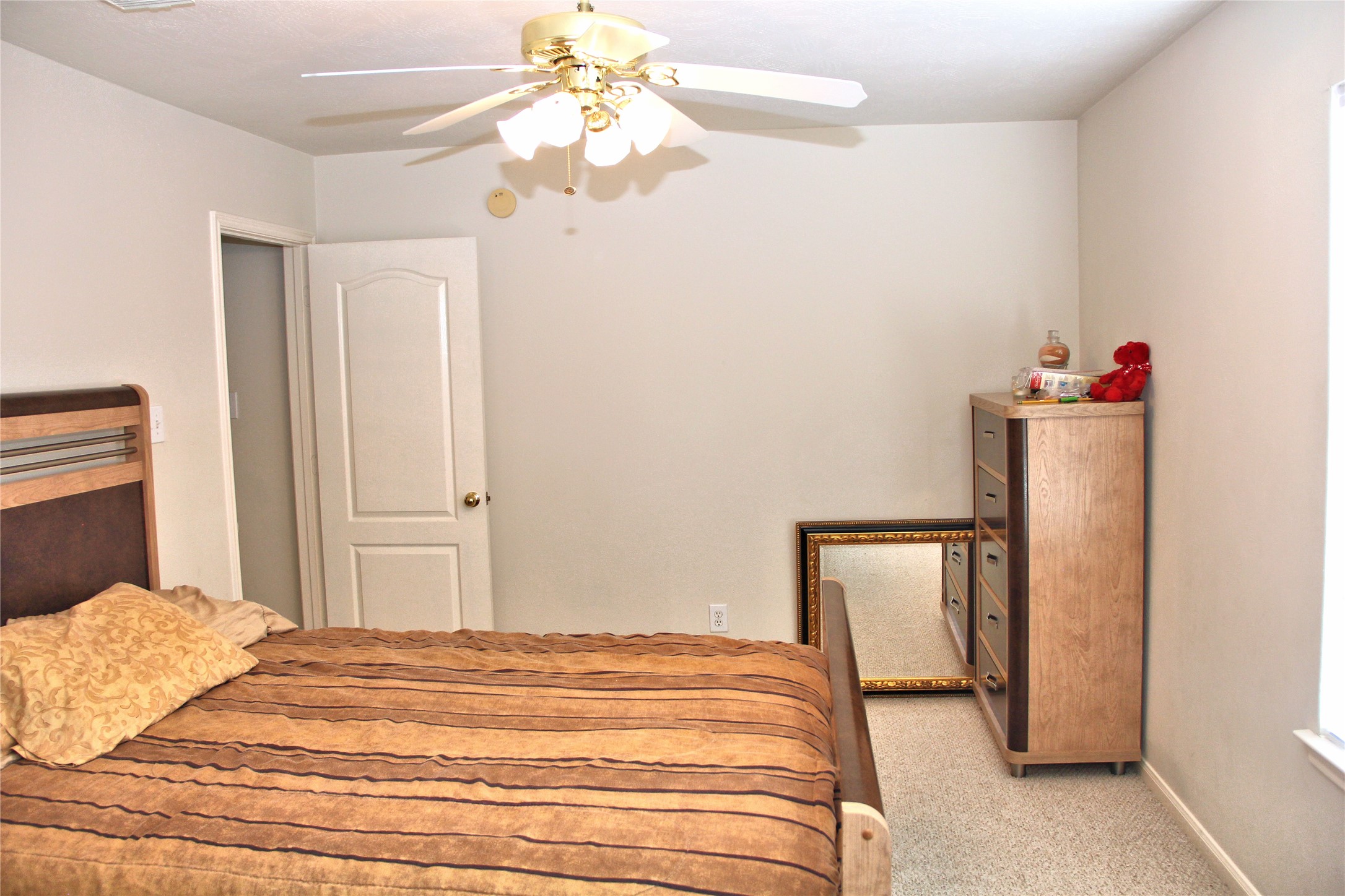 10234 Turrett Point Lane Houston, TX 77064 - Photo 10 of 17 a bedroom with a bed and a chandelier