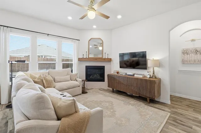 a living room with furniture fireplace and flat screen tv