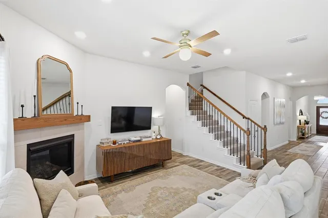 a living room with furniture kitchen view and a chandelier