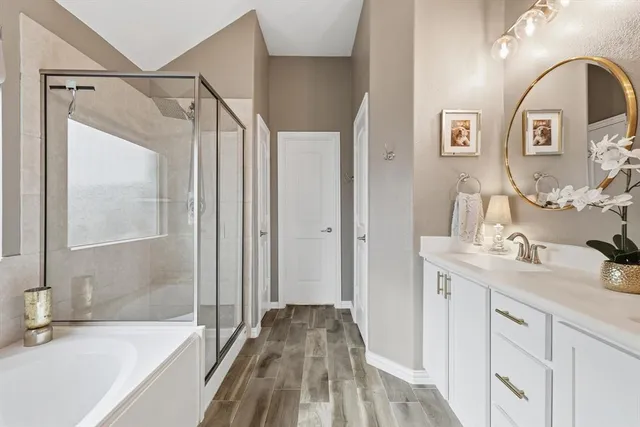 a bathroom with a tub and shower