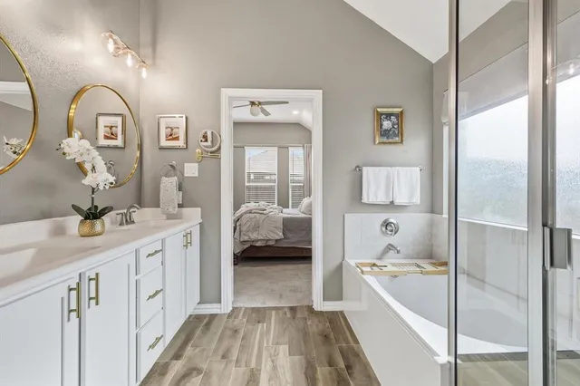 a bathroom with a double vanity sinks and a mirror