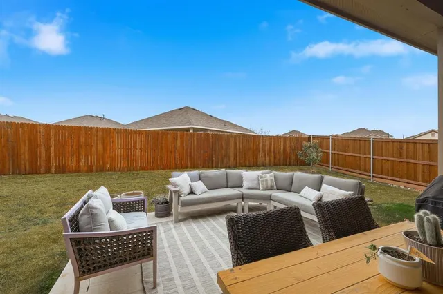 a view of a backyard with table and chairs