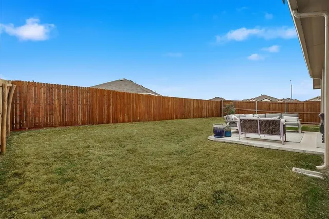 a view of a house with a yard and deck