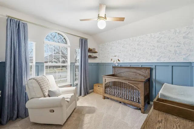 a bedroom with furniture and a large window