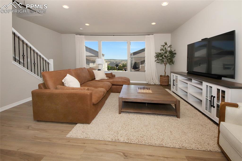 6069 Inman View Colorado Springs, CO 80924 - Photo 12 of 38 a living room with furniture and a flat screen tv