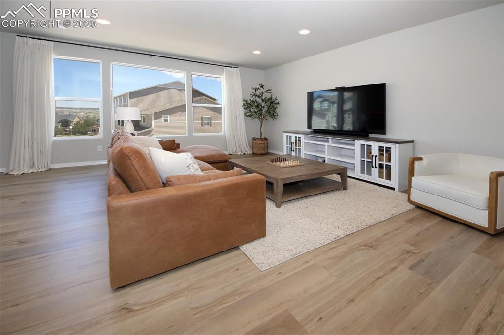 6069 Inman View Colorado Springs, CO 80924 - Photo 13 of 38 a living room with furniture and a flat screen tv