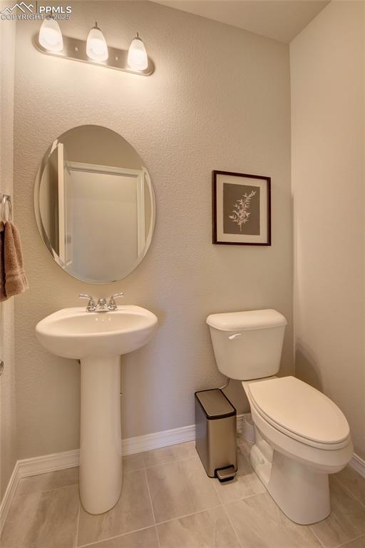 6069 Inman View Colorado Springs, CO 80924 - Photo 16 of 38 a bathroom with a toilet sink and mirror