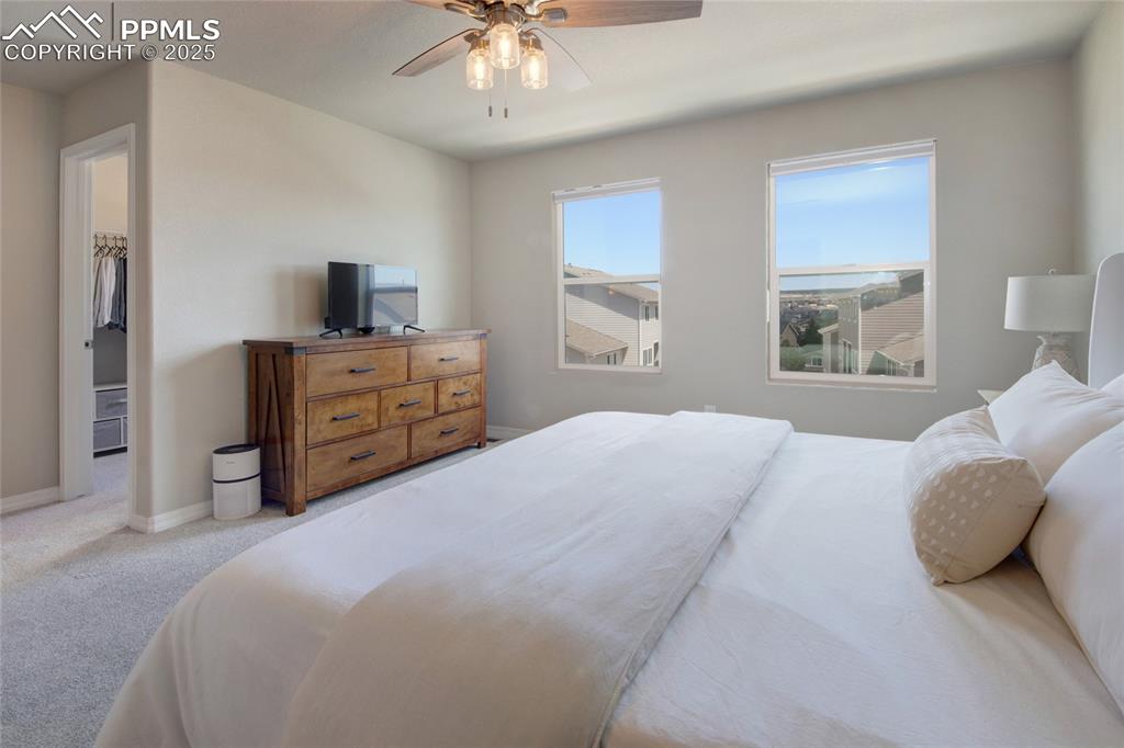6069 Inman View Colorado Springs, CO 80924 - Photo 19 of 38 a bedroom with a bed and a television