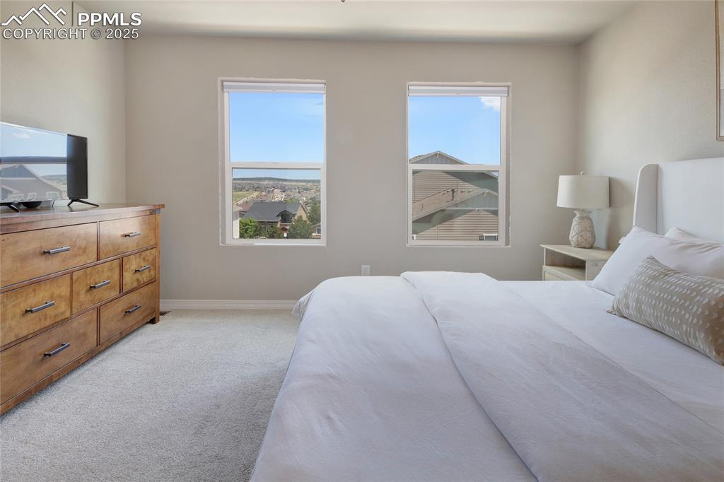 6069 Inman View Colorado Springs, CO 80924 - Photo 20 of 38 a bedroom with a bed and a window