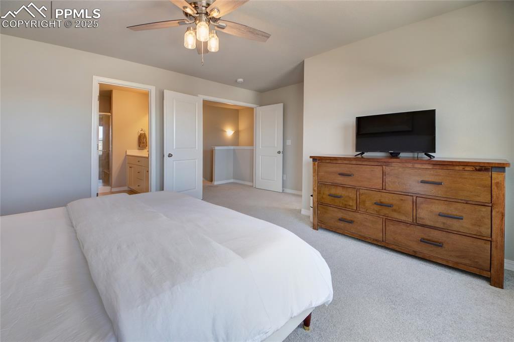 6069 Inman View Colorado Springs, CO 80924 - Photo 22 of 38 a bedroom with a bed and a television