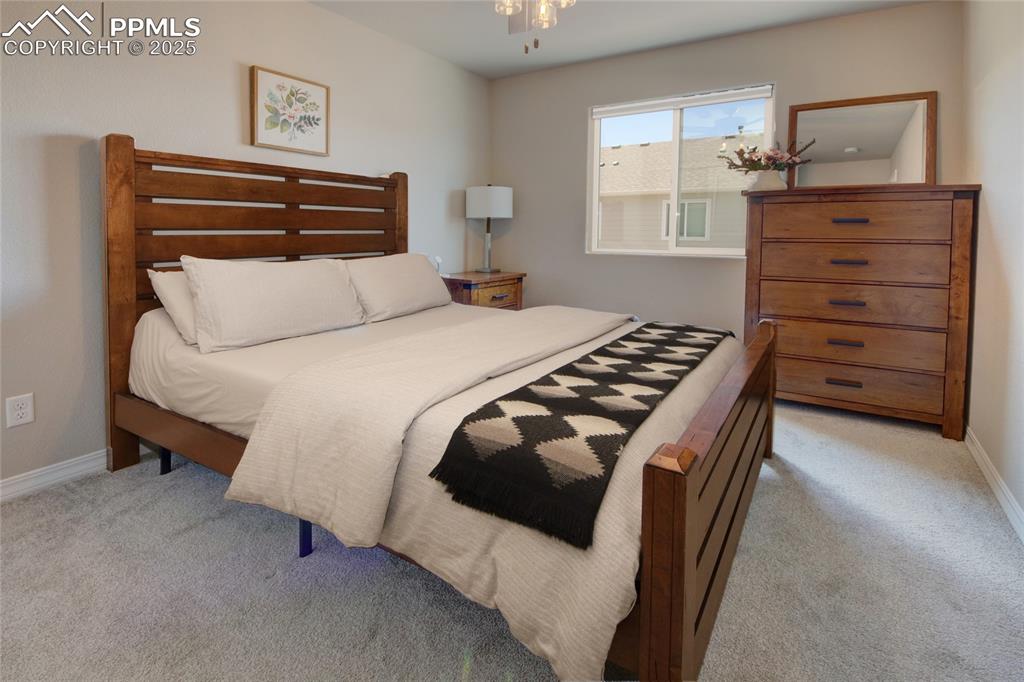 6069 Inman View Colorado Springs, CO 80924 - Photo 28 of 38 a bedroom with a bed and dresser
