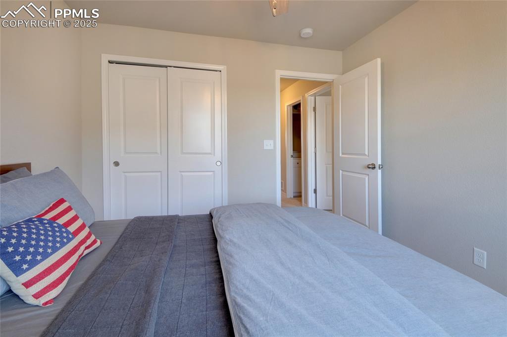 6069 Inman View Colorado Springs, CO 80924 - Photo 31 of 38 a bedroom with a bed and a painting on the wall