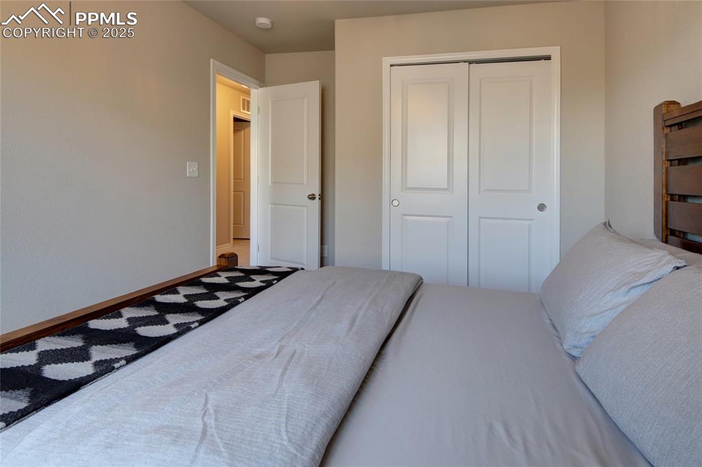 6069 Inman View Colorado Springs, CO 80924 - Photo 33 of 38 a bedroom with a bed and a tv