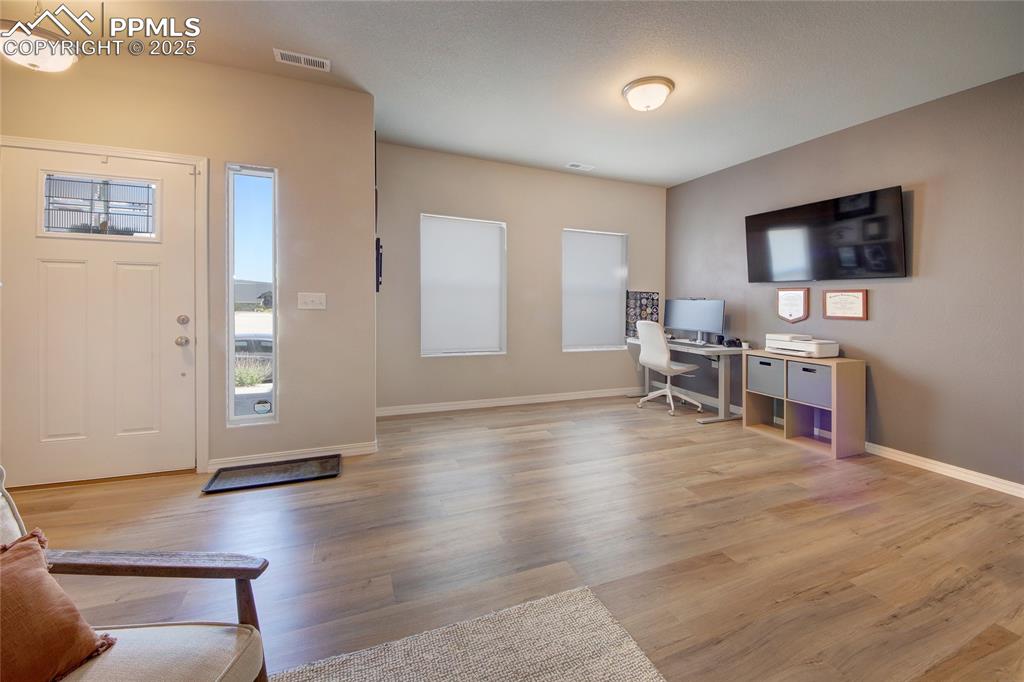 6069 Inman View Colorado Springs, CO 80924 - Photo 4 of 38 a living room with furniture and wooden floor