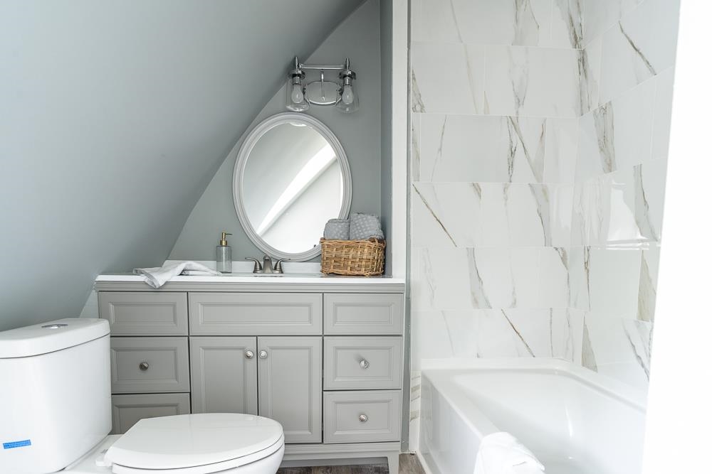 660 Tryme Road Reva, VA 22735 - Photo 12 of 40 a bathroom with a granite countertop toilet sink and mirror