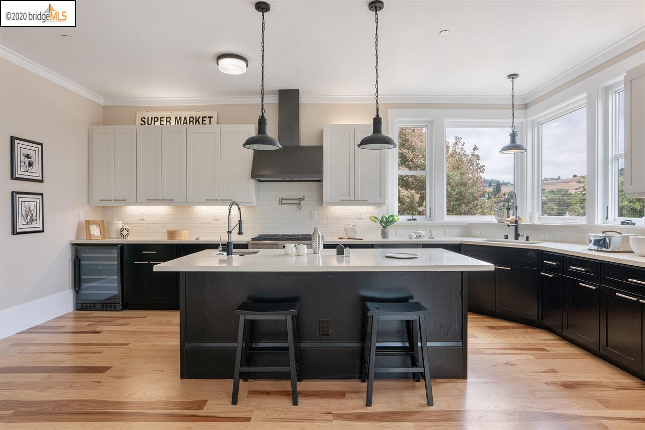 a kitchen with stainless steel appliances granite countertop a sink and a stove