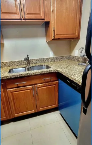 a kitchen with granite countertop cabinets and sink