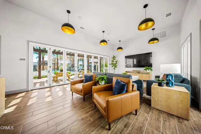 a living room with dining table and chairs