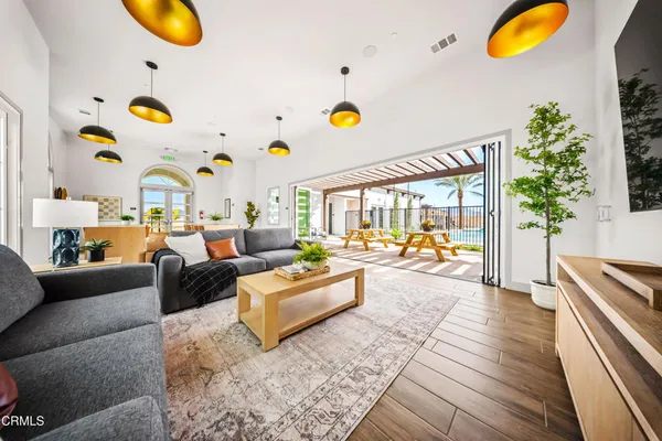 a living room with patio furniture and a large window