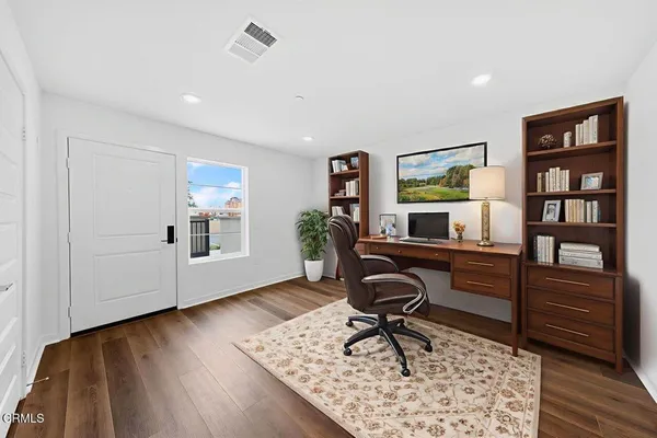 a workspace with furniture and wooden floor