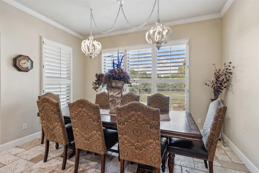 4180 North Smith Road Fate, TX 75087 - Photo 11 of 27 Tiled dining room with a chandelier and crown molding