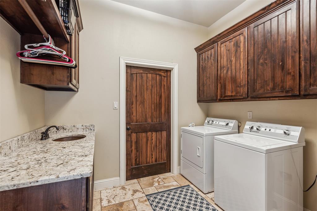 4180 North Smith Road Fate, TX 75087 - Photo 13 of 27 Laundry area featuring sink, independent washer and dryer, cabinets, and light tile patterned floors