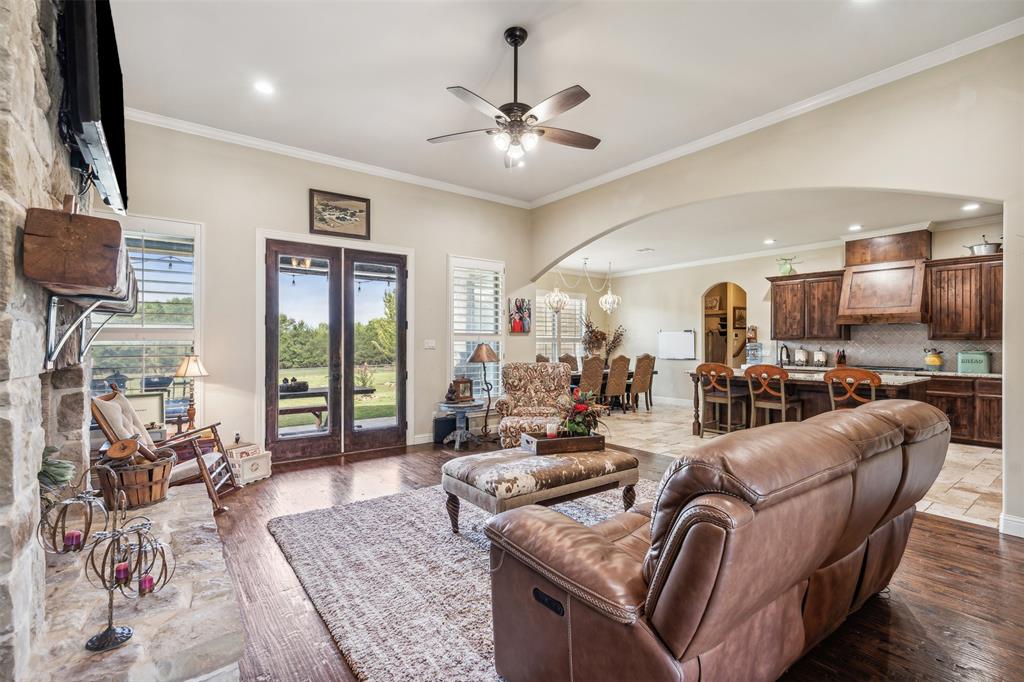 4180 North Smith Road Fate, TX 75087 - Photo 5 of 27 Living room with wood-type flooring, crown molding, french doors, and ceiling fan