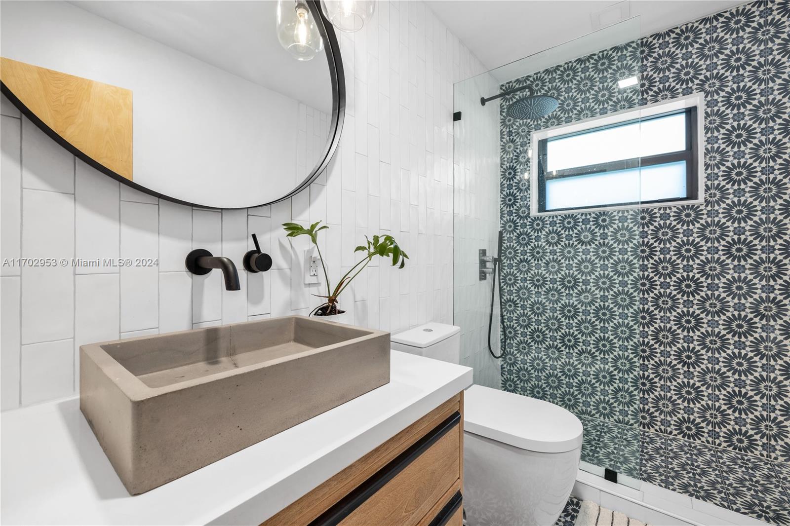 56 Northeast 46th Street Miami, FL 33137 - Photo 13 of 28 a bathroom with a sink a toilet and mirror