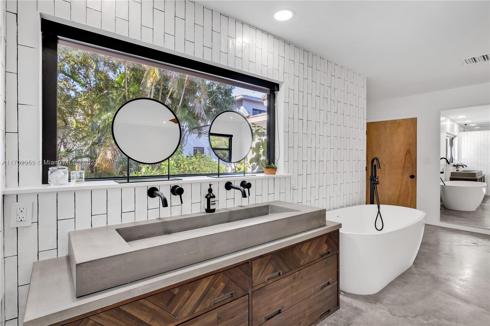 56 Northeast 46th Street Miami, FL 33137 - Photo 15 of 28 a bathroom with a sink a mirror and a toilet