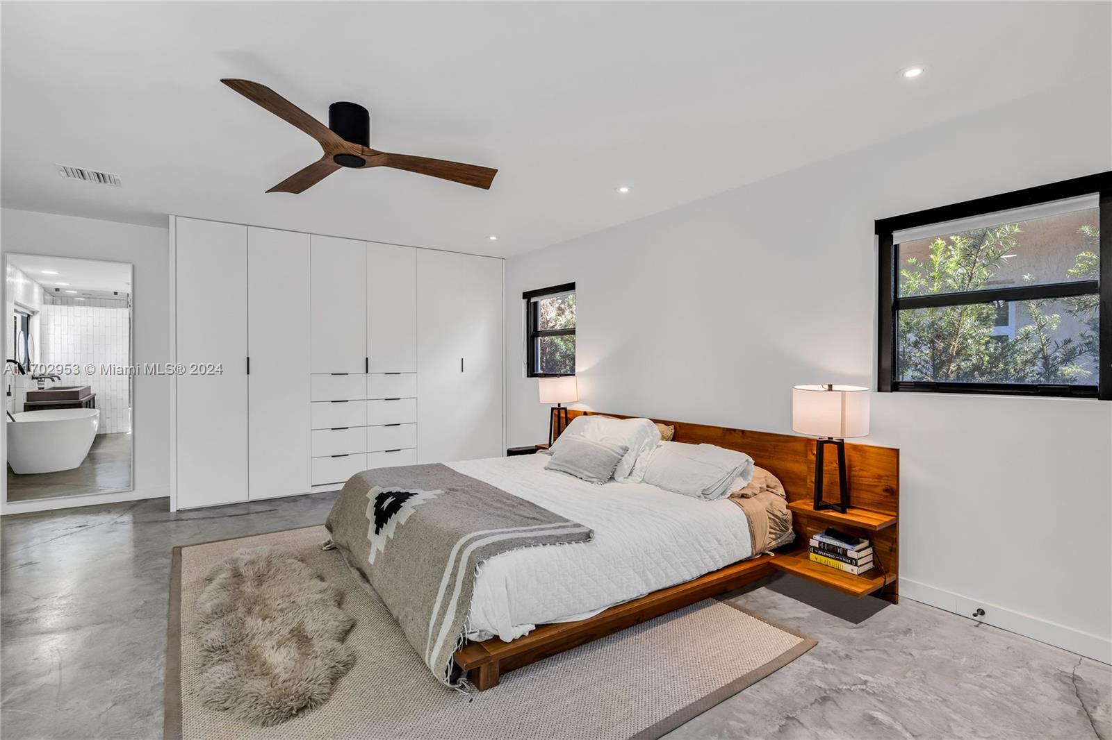 56 Northeast 46th Street Miami, FL 33137 - Photo 16 of 28 a bedroom with a bed and a view of bathroom