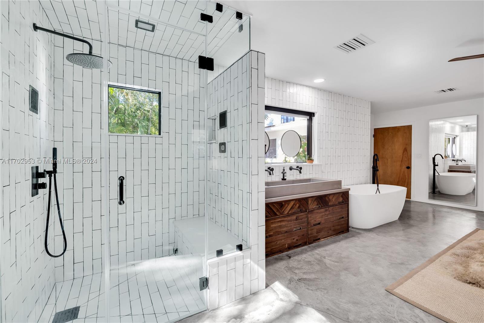 56 Northeast 46th Street Miami, FL 33137 - Photo 18 of 28 a bathroom with a tub sink and mirror