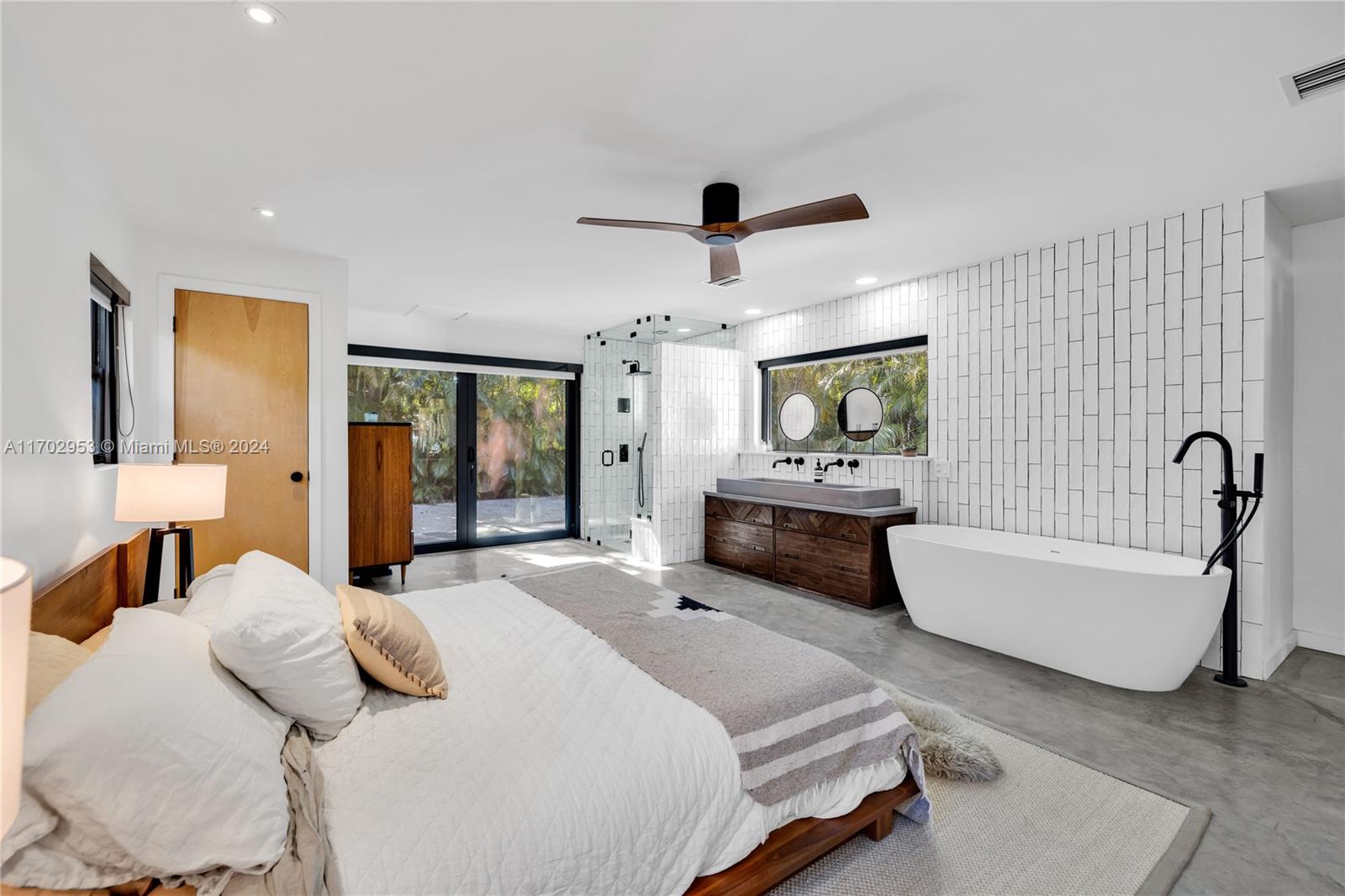 56 Northeast 46th Street Miami, FL 33137 - Photo 20 of 28 a bedroom with a bed couch and window