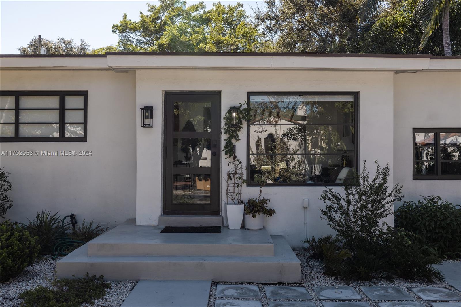 56 Northeast 46th Street Miami, FL 33137 - Photo 24 of 28 a front view of a house with garden